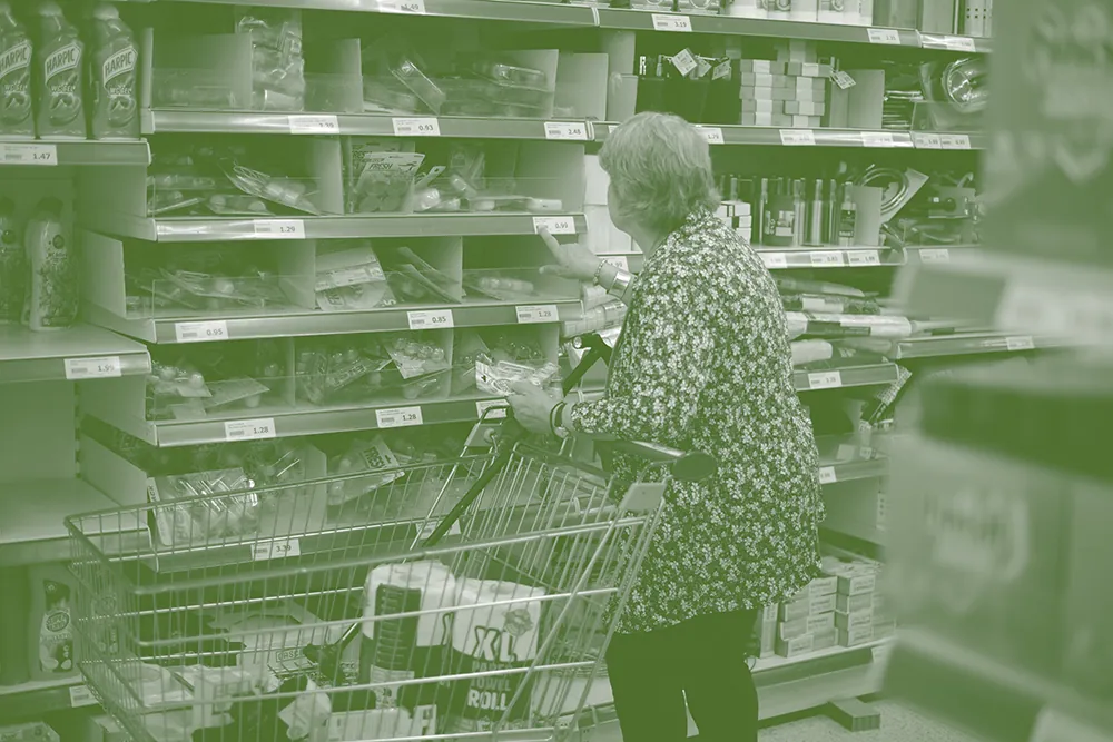 Oudere vrouw doet boodschappen in de supermarkt